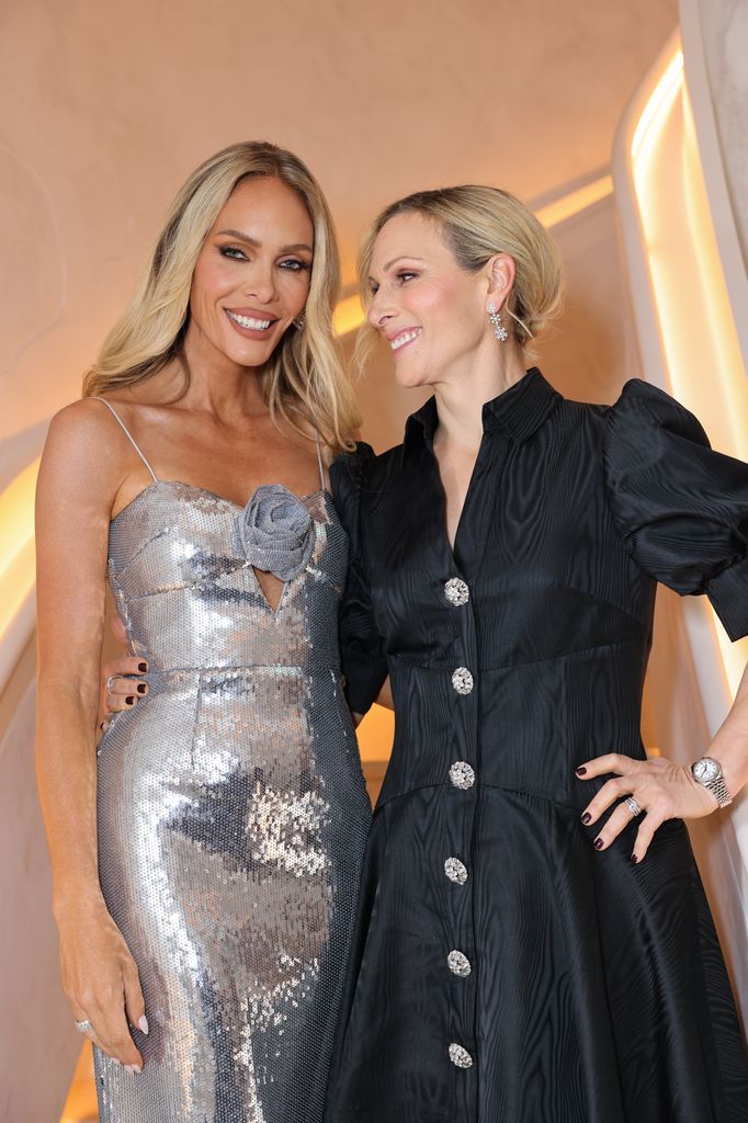 Rebecca Vallance in a silver dress standing with Zara Tindall in a black mini dress