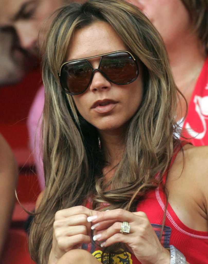 Victoria Beckham in a red top with long hair