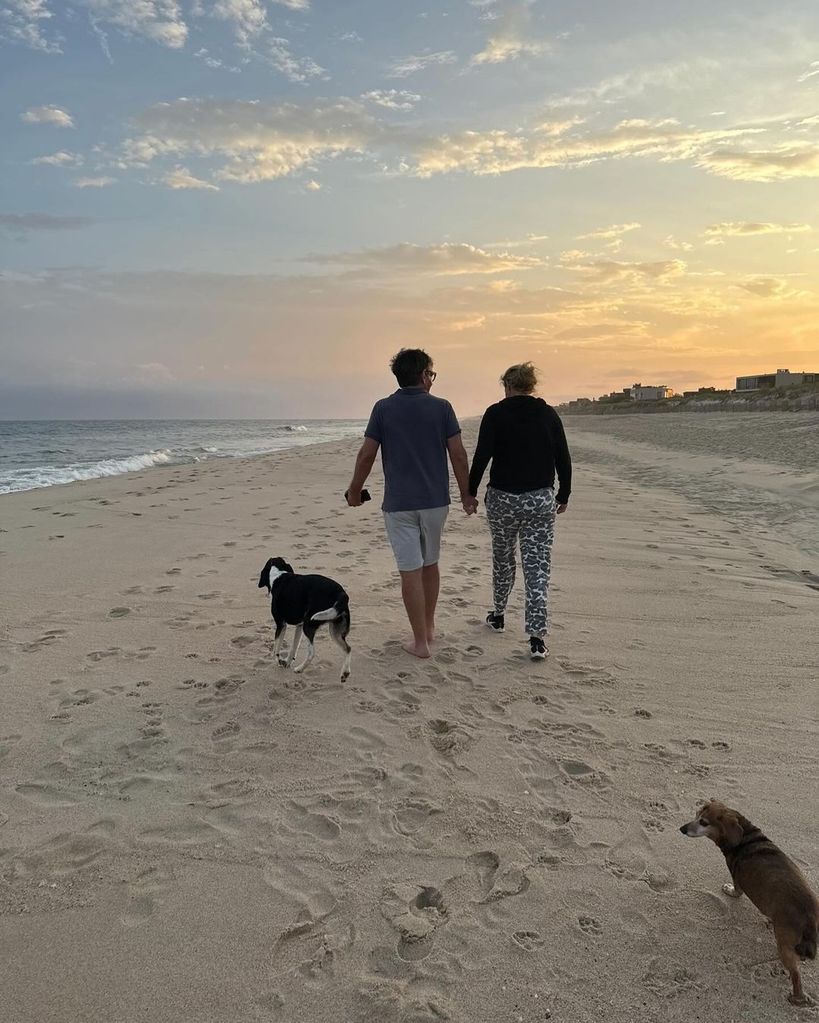 George Stephanopoulos and wife Ali Wentworth hold hands as they walk on the beach with their pet dog, shared on Instagram