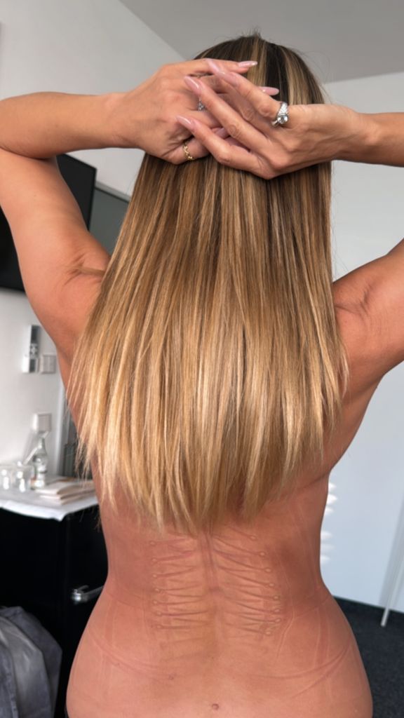 Heidi Klum bare back with corset marks