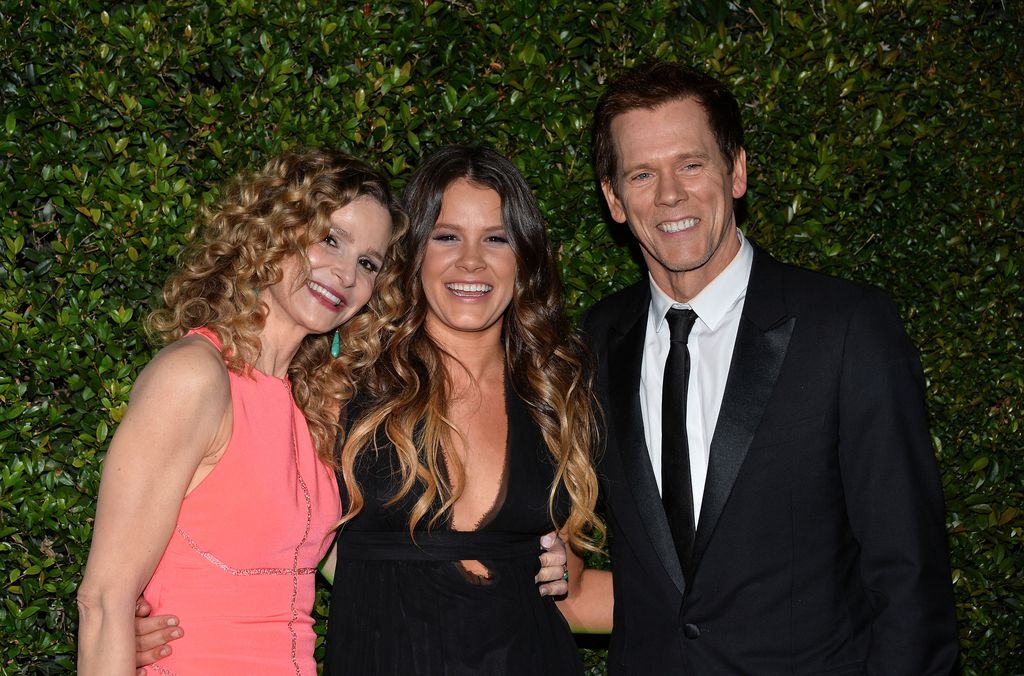 Kevin, Sosie and Kyra smiling wide on the red carpet for a party in 2014