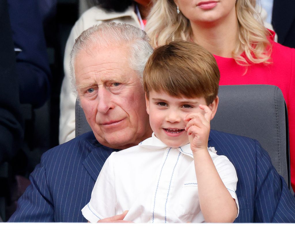 Prince Louis sits on his grandfather's lap as they attend the Platinum Pageant in 2022