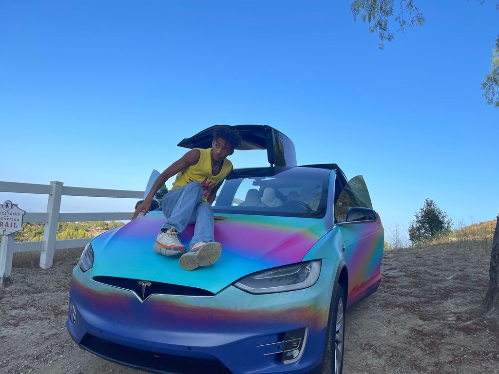 Jaden Smith posing on bonnet of car