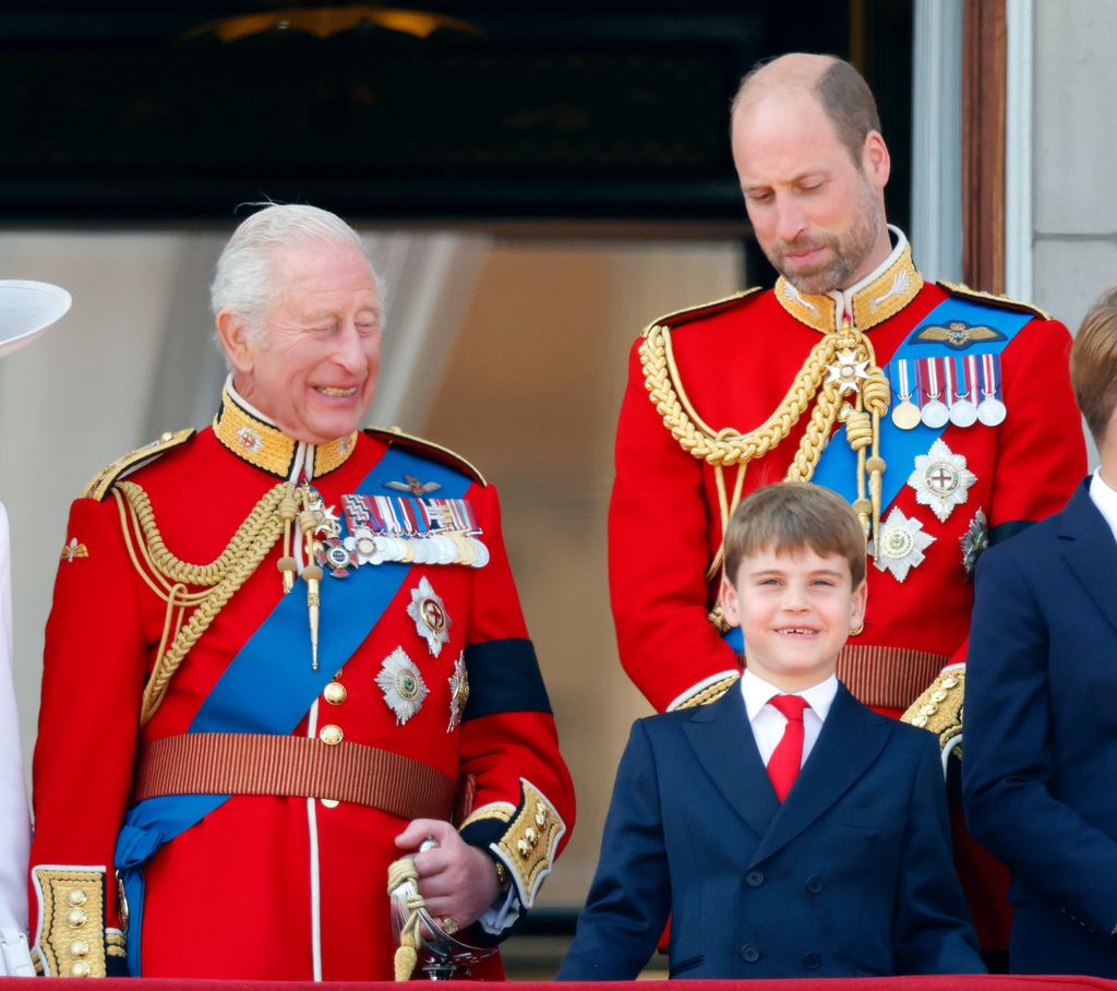 King Charles III, dressed in his ceremonial Coldstream Guards uniform, was seen sharing a warm smile with his youngest grandson, Prince Louis who was wearing a navy suit and red tie. Prince William dressed in his ceremonial Coldstream Guards uniform stood behind his son. 