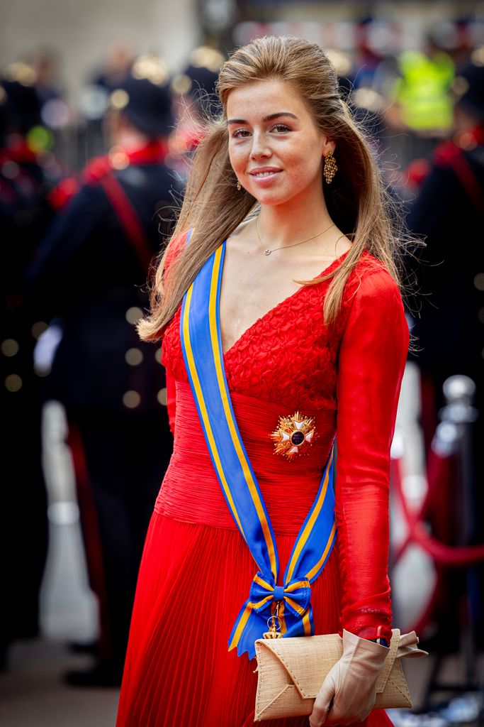 Princess Alexia in red gown with blue sash