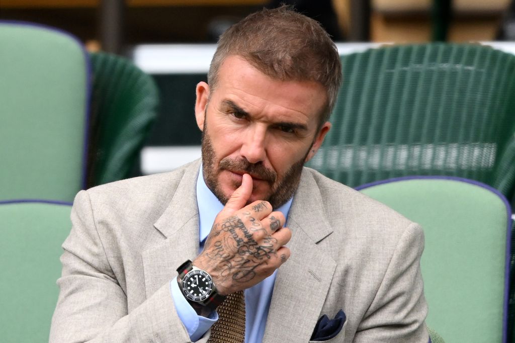 David Beckham looking straight ahead to the camera while sitting in the royal box of Wimbledon