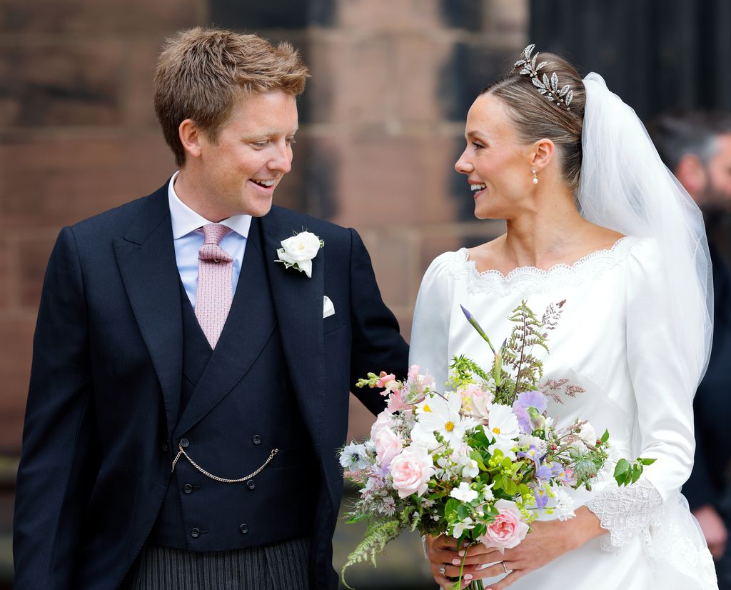Duke and Duchess of Westminster smiling at each other after wedding