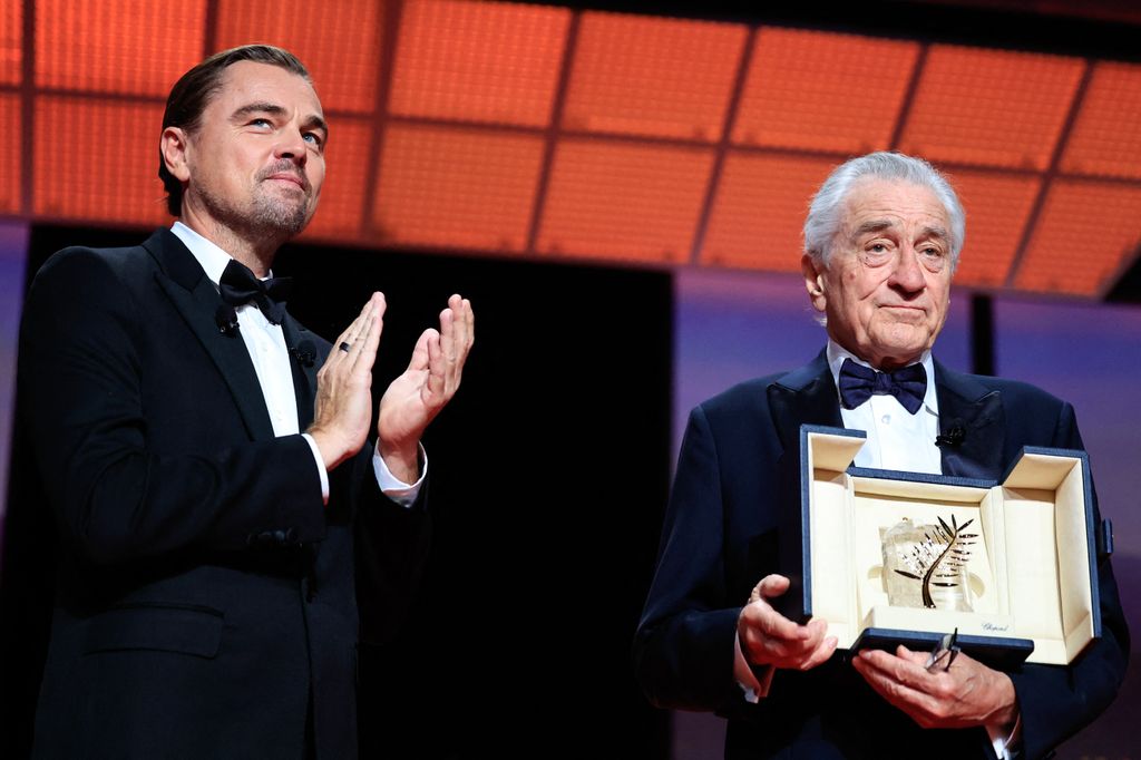 US actor Robert De Niro (R) receives the Honorary Palme d'Or from US actor Leonardo Dicaprio