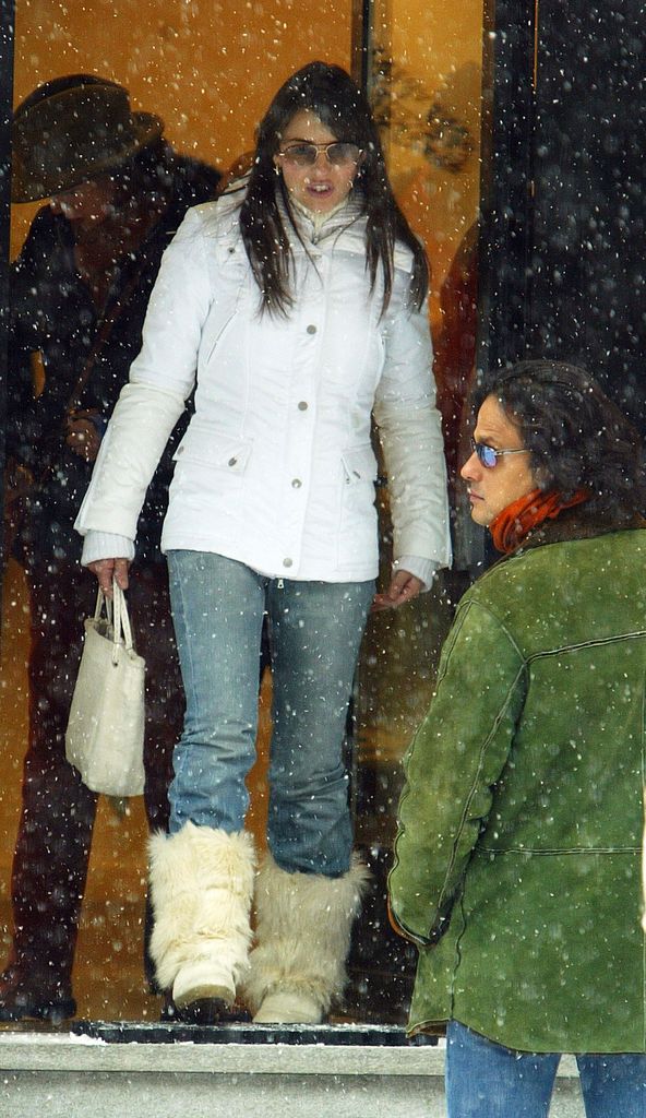 Actress Elizabeth Hurley (L) shops with boyfriend Arun Naya in a white coat and fur boots