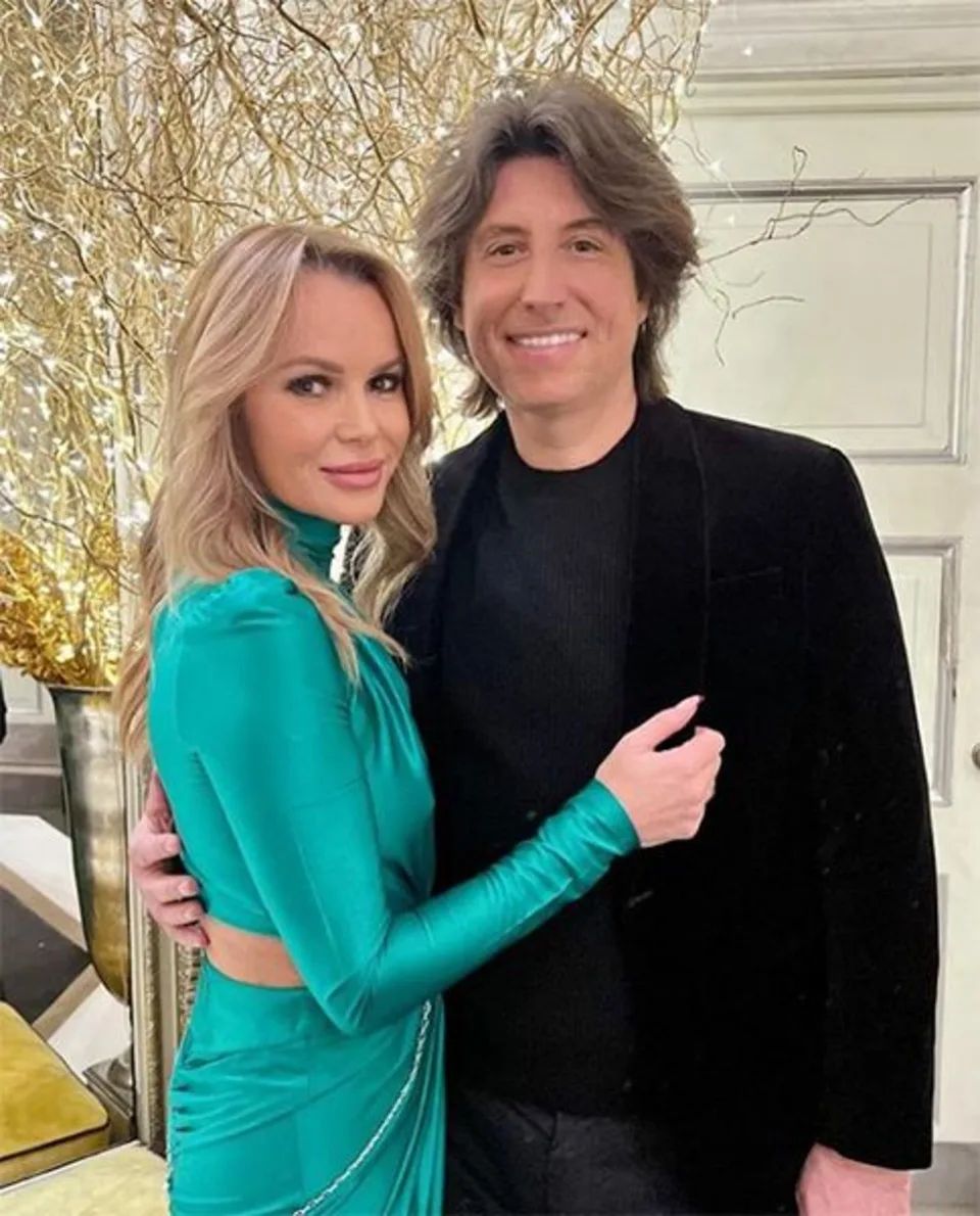 Amanda Holden in a green dress hugging Chris Hughes
