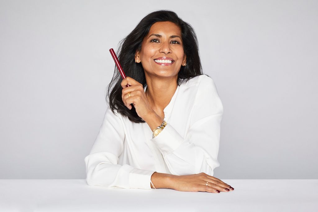 Smiling woman holding a pen