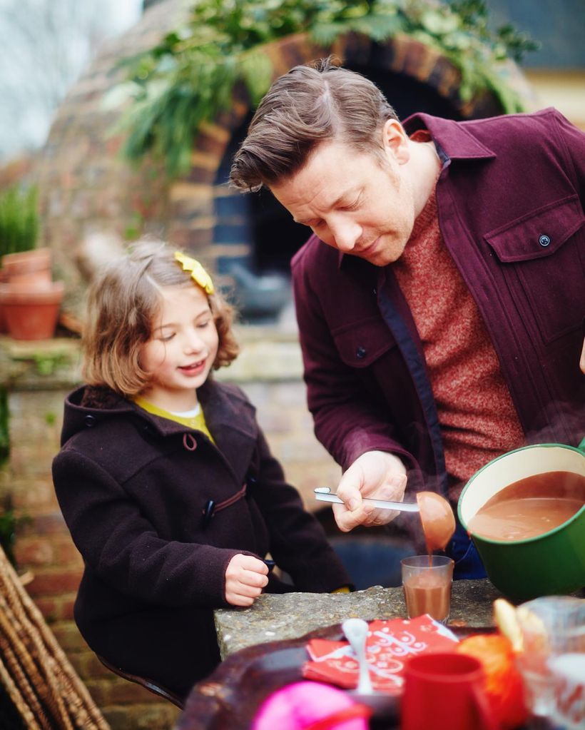 Jamie pouring hot chocolate in garden with Petal