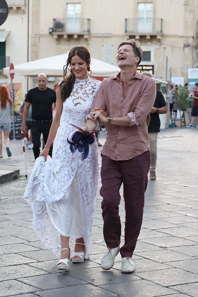 Fuschia Kate Sumner in white dress with husband laughing