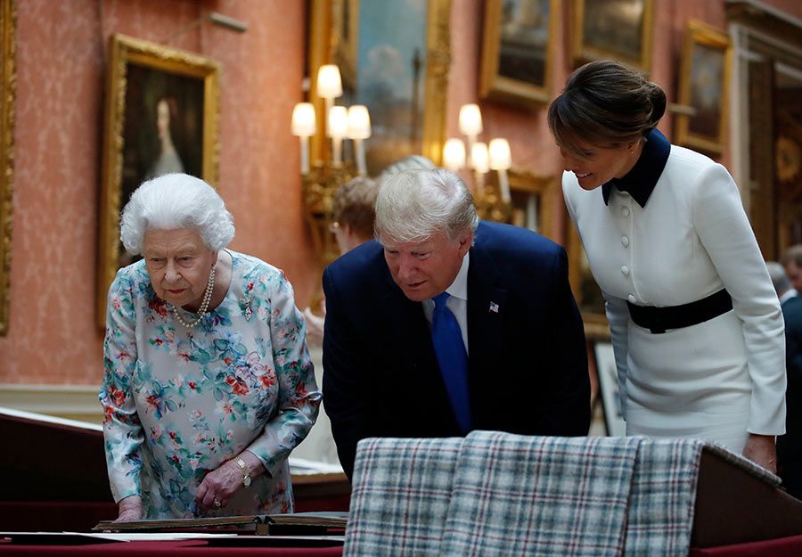 melania smiling as queen shows gifts