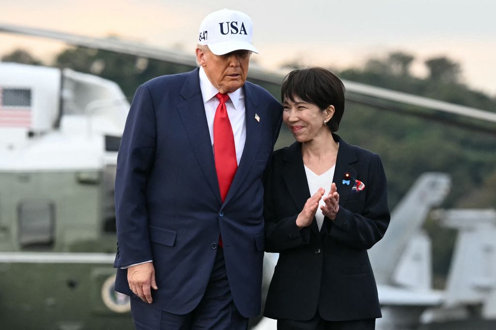 Donald Trump (L) and Japan's Prime Minister Sanae Takaichi arrive on board the US Navy's USS George Washington aircraft carrier at the US naval base in Yokosuka on October 28, 2025