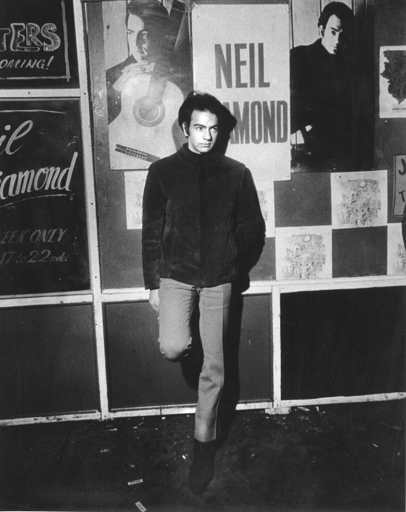 Neil Diamond poses for a portrait in front of a marquee advertising a club where he is performing an engagement in circa 1967