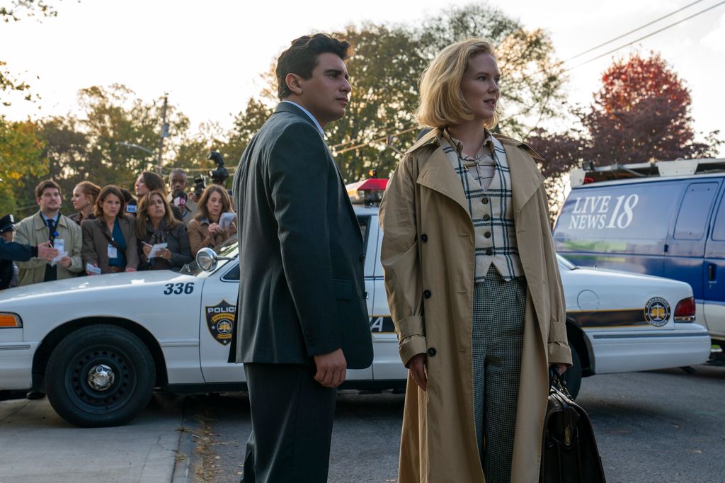 man and woman standing in front of police car