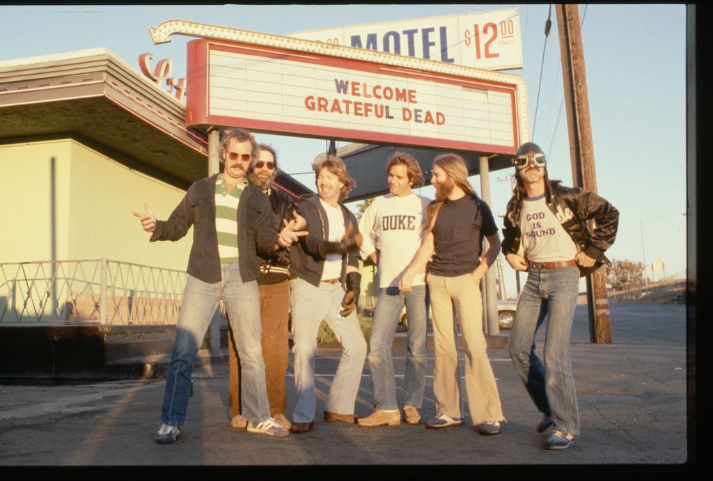 Members of the rock group Grateful Dead: Bill Kreutzman (striped shirt), Jerry Garcia (black shirt and jacket), Mickey Hart ("God is Sound" T-shirt), Phil Lesh (white T-shirt), Bob Weir (Duke sweatshirt), and Brent Mydland. 