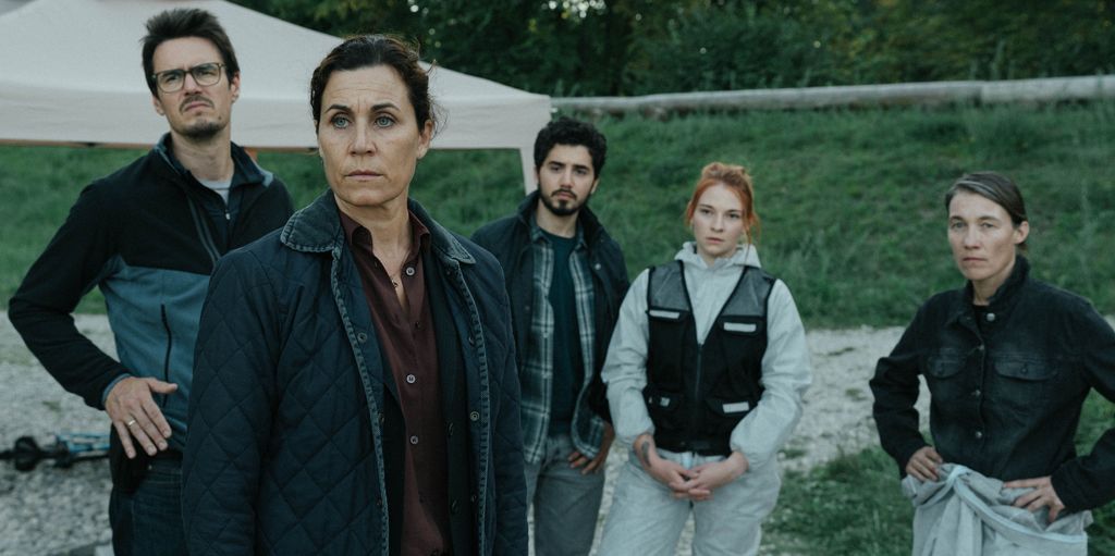 group of people standing in field
