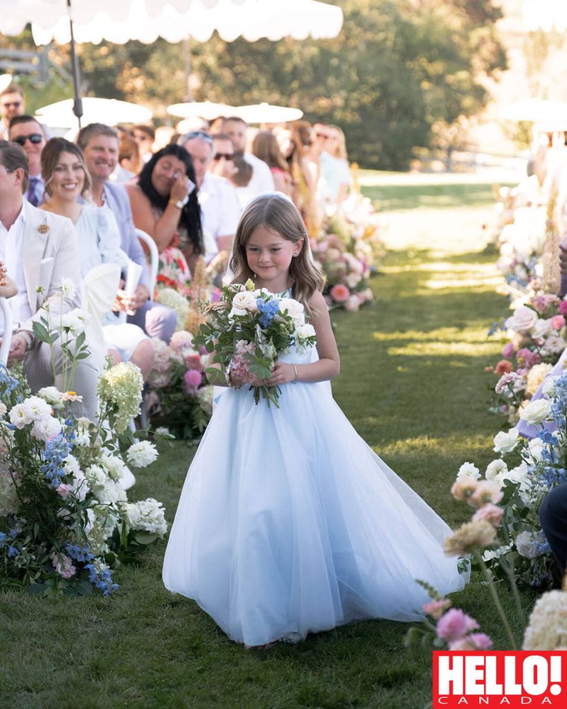 Annie walks down the aisle looking just like mom in a dress from Candè Bridal Boutique.