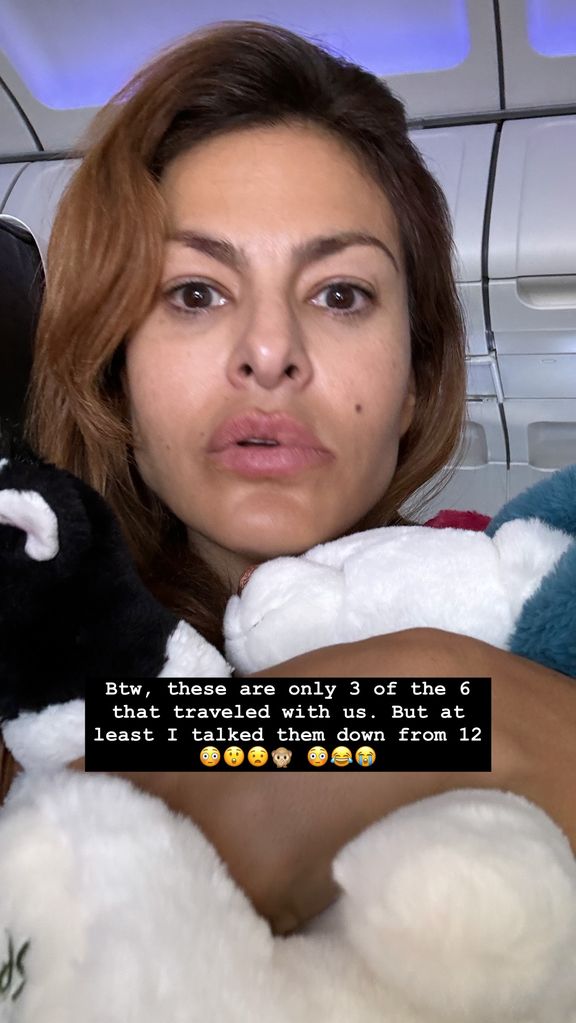 Eva Mendes holds her daughter's stuffed animals on the plane