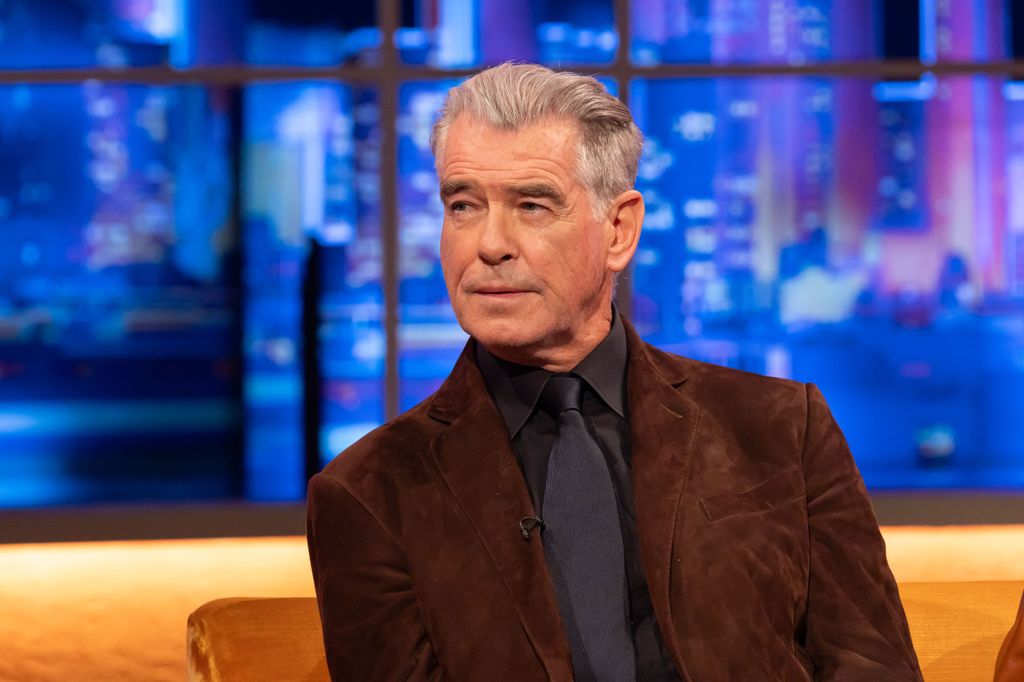 close-up man wearing suit sitting on sofa in tv studio