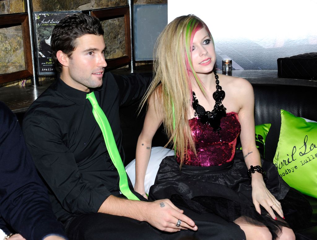 Avril and Brody sat on a sofa