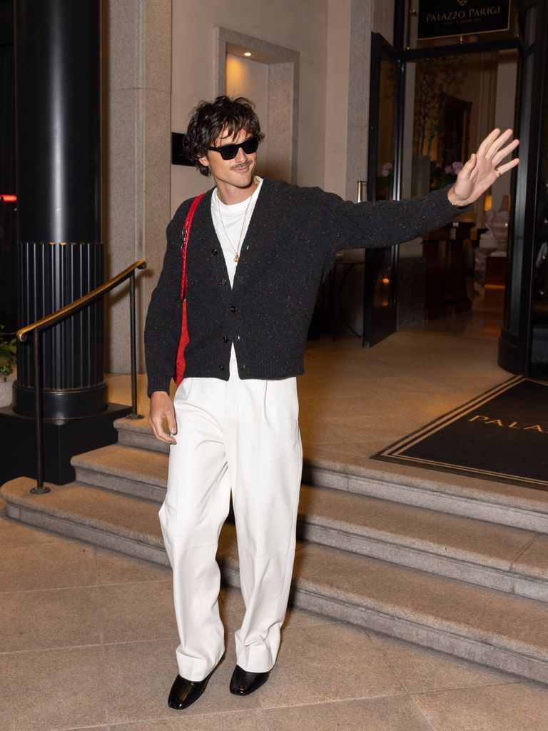 A photo of Jacob Elordi wearing white trousers 