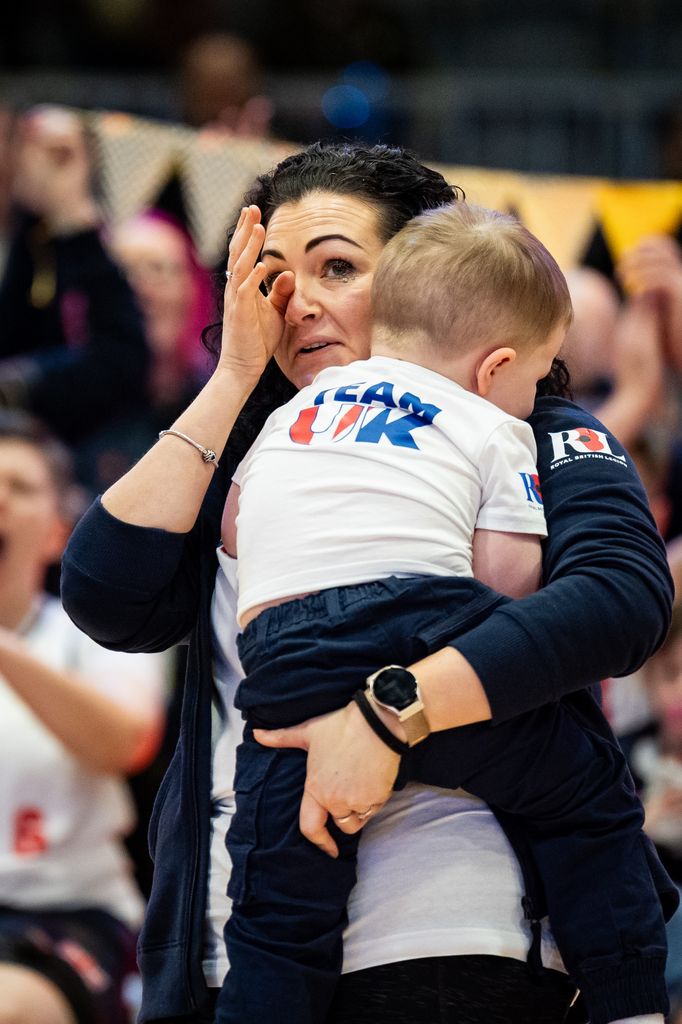 The partner of Army veteran James Cairns, Hannah Wild holding their son Arthur