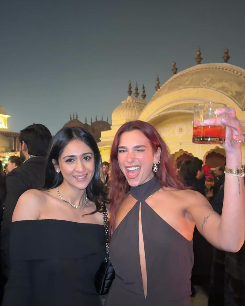 Dua with friend holding drink
