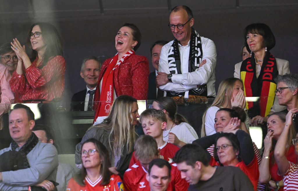 Queen Mary in stands watching handball game