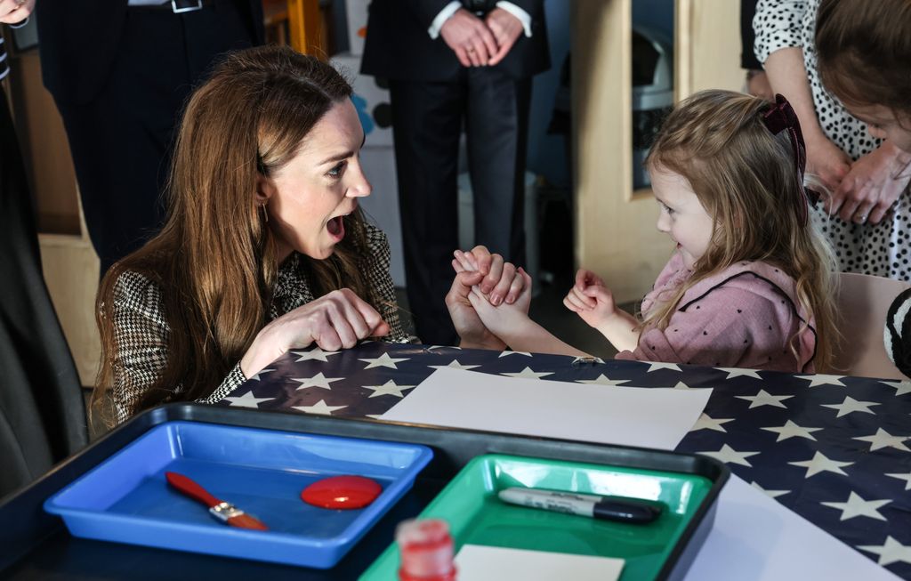 Woman sat with little girl smiling at each other