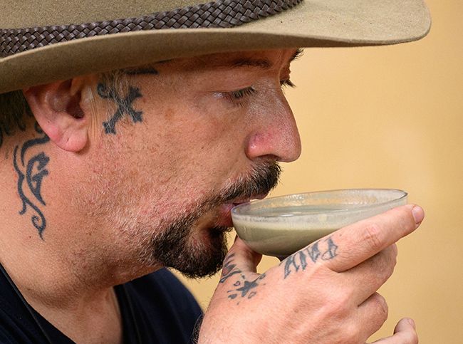 Boy George drinking from a smoothie