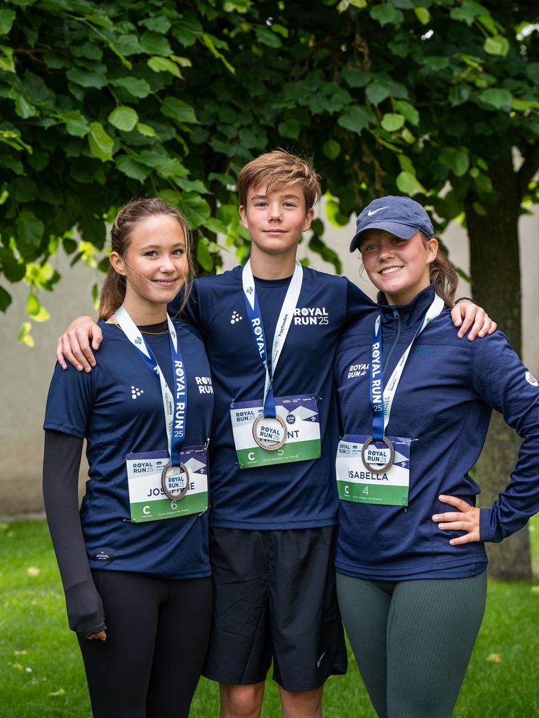Josephine, Vincent and Isabella in running kit with their medals