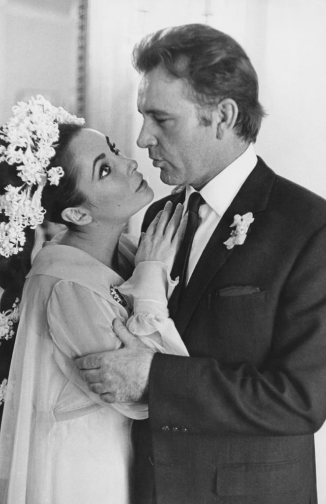 Elizabeth and Richard at their wedding looking at each other