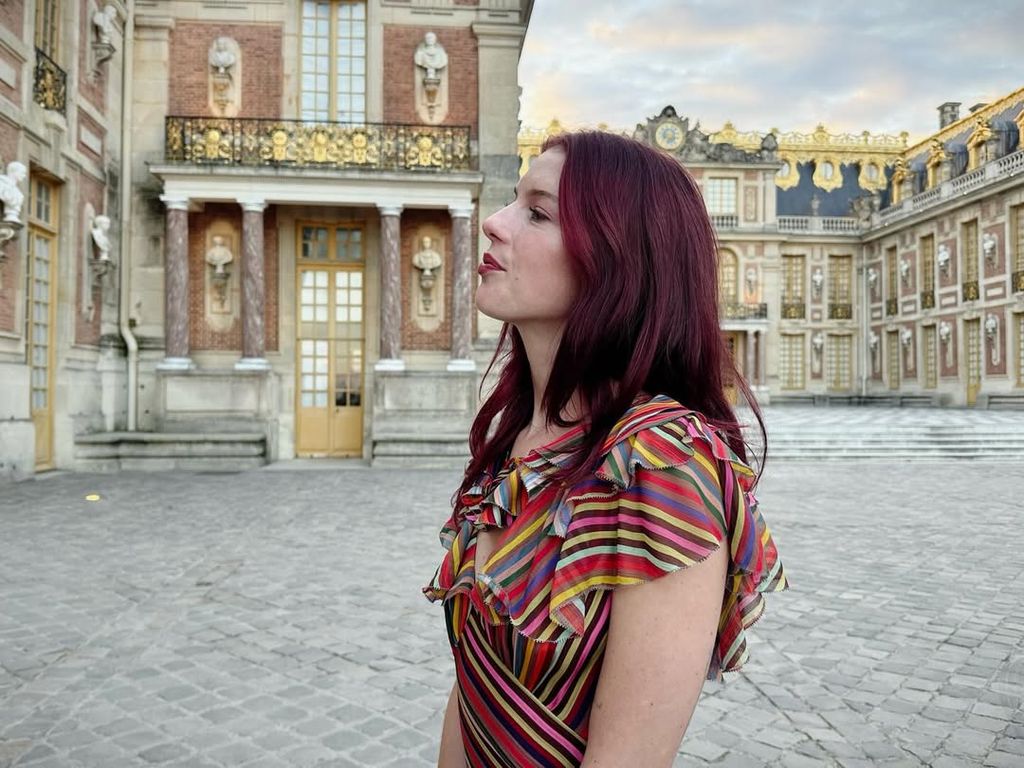Maggie McGraw poses for a photo in Versailles showing off her red hair, shared on Instagram
