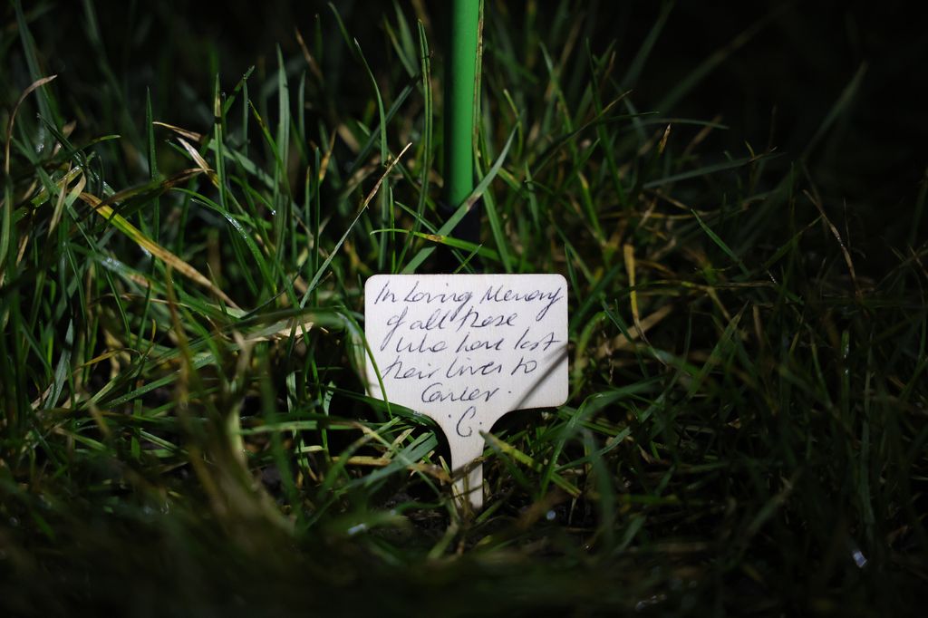 A message in the grass reading: 'In loving memory of all those who have lost their lives to cancer.'