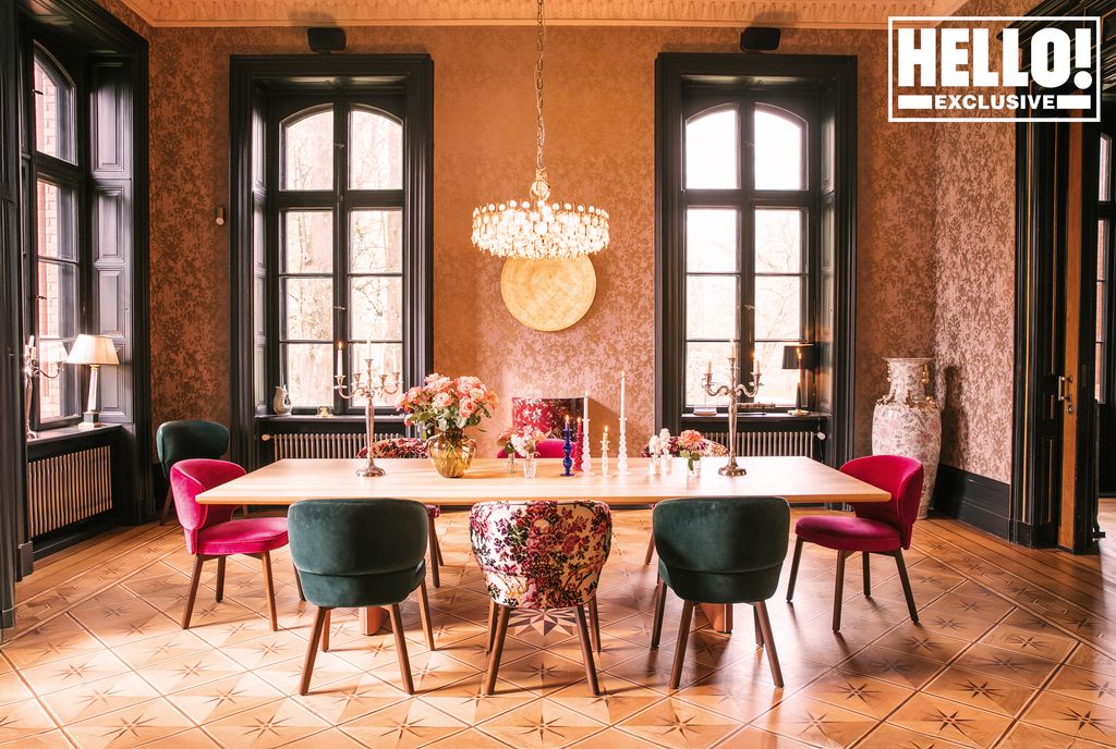 Long dining table with blue and pink chairs