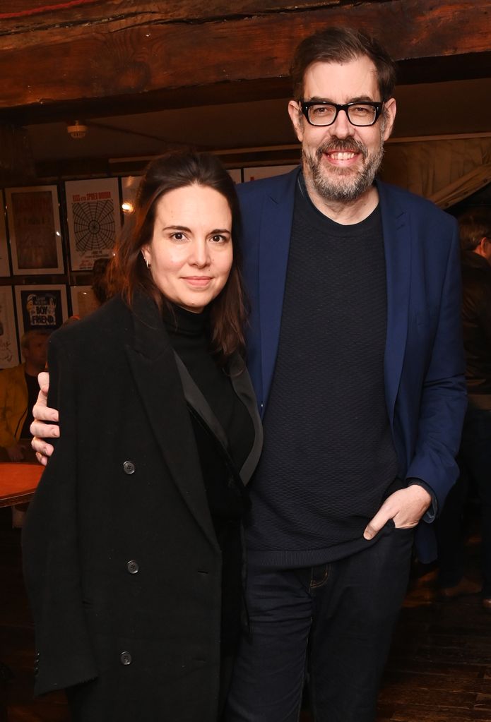 Ingrid Oliver in a black jacket with her husband Richard Osman in a blue suit