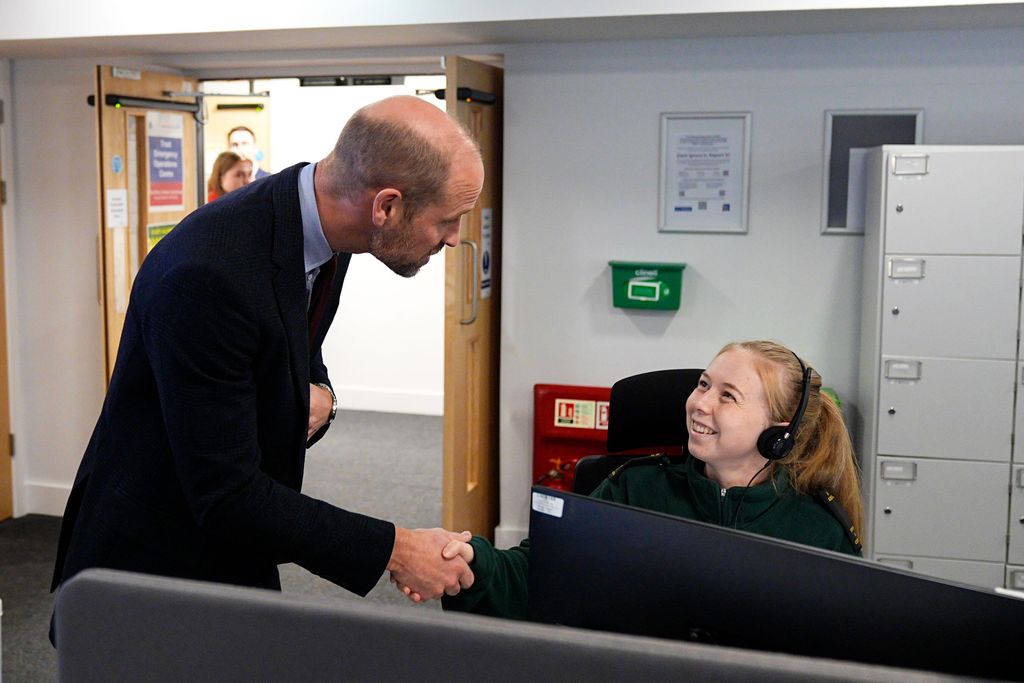 The Prince of Wales meets a call handler in the Emergency Operations Control room, where 999 calls are managed 24/7