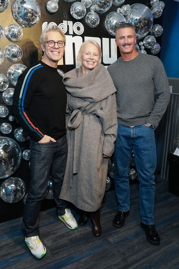 Andy Cohen, Pamela Anderson and John Hill visits SiriusXM Studios on January 14, 2026 in New York City.
