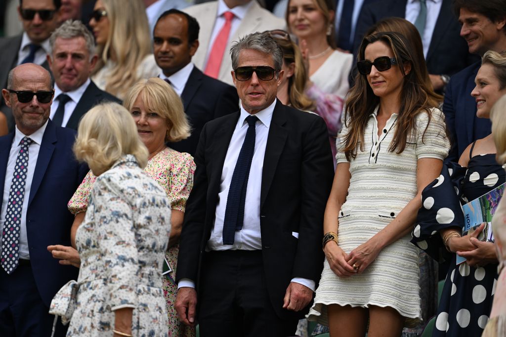 Queen Camilla walking past Hugh Grant and Anna Eberstein