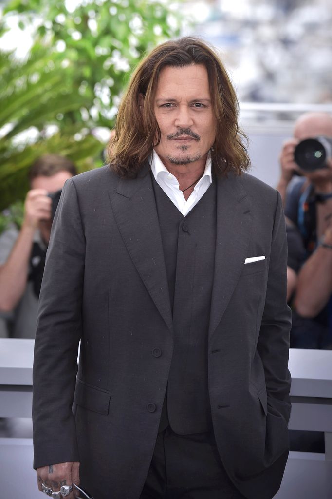 Johnny Depp posing for photos on the Cannes red carpet