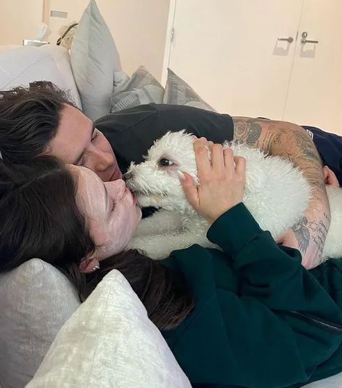 nicola kissing dog alongside husband brooklyn