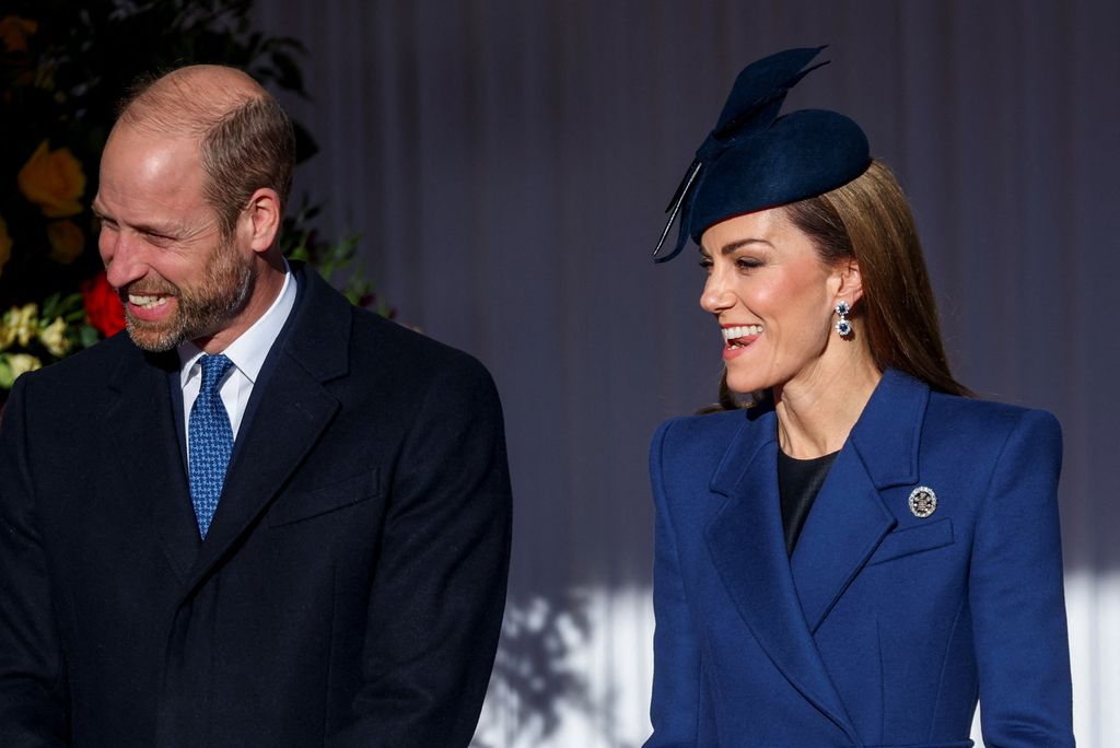 Kate was pictured smiling while biting her tongue 