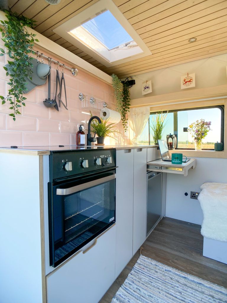 Pink kitchen inside a van