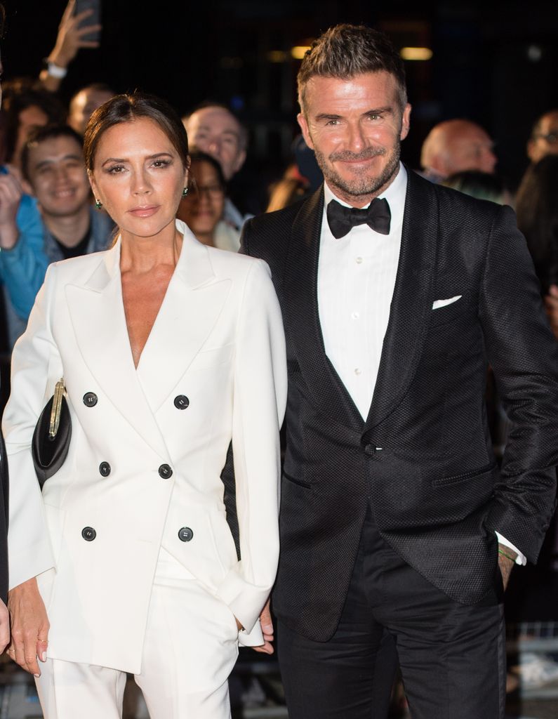 Victoria and David Beckham in a white suit and tuxedo