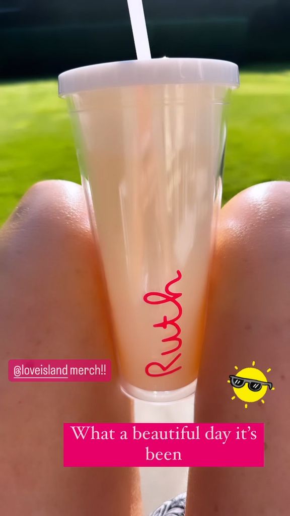 Photo of a woman's legs sunbathing with a waterbottle between her knees