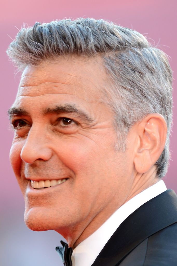 Actor George Clooney smiling in suit