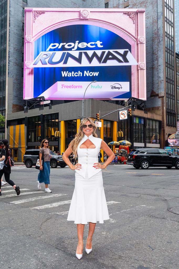 Heidi Klum posing in front of Project Runway billboard